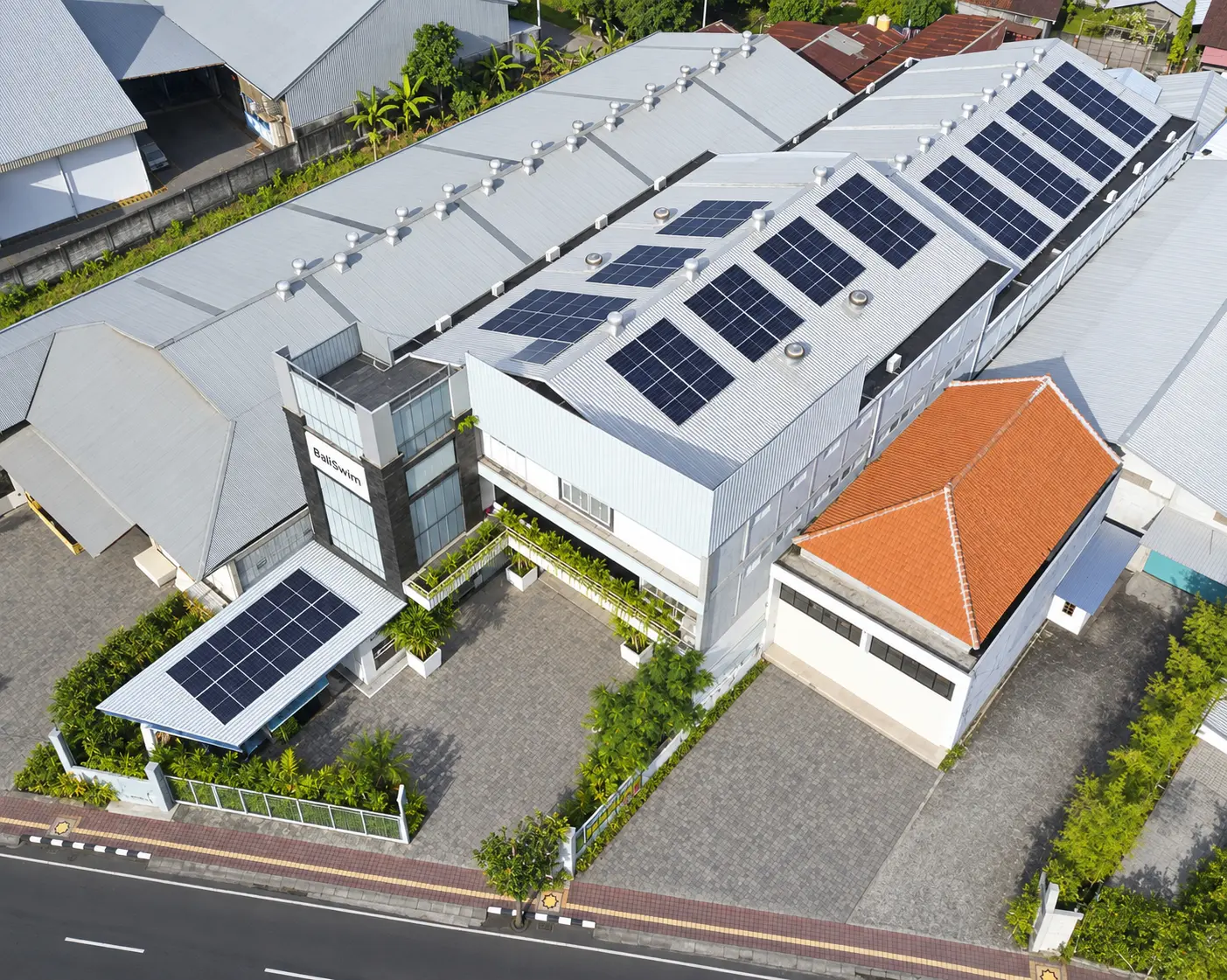 Aerial view of solar panels across the roof of the Bali Swim factory