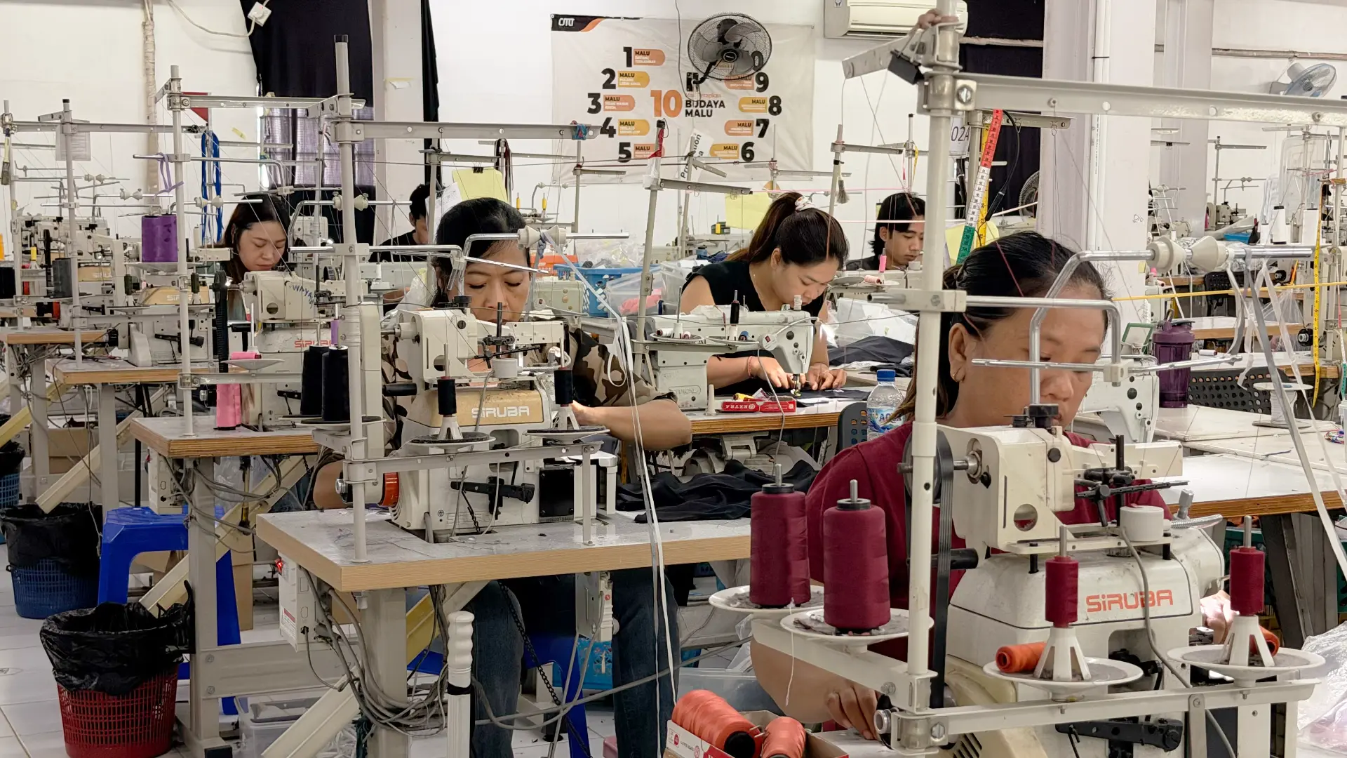 Bali Swim team sewing swimwear on industrial machines on the factory floor